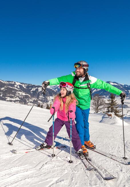 father and daughter skiing